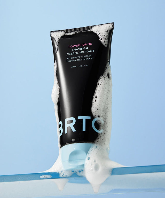 Image of BRTC Power Homme Shaving & Cleanser Foam 150ml with foamy texture on light blue background.