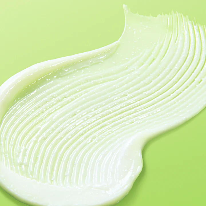 Texture of BY WISHTREND Green Tea & Ceramide Barrier Cream 50g on a green background