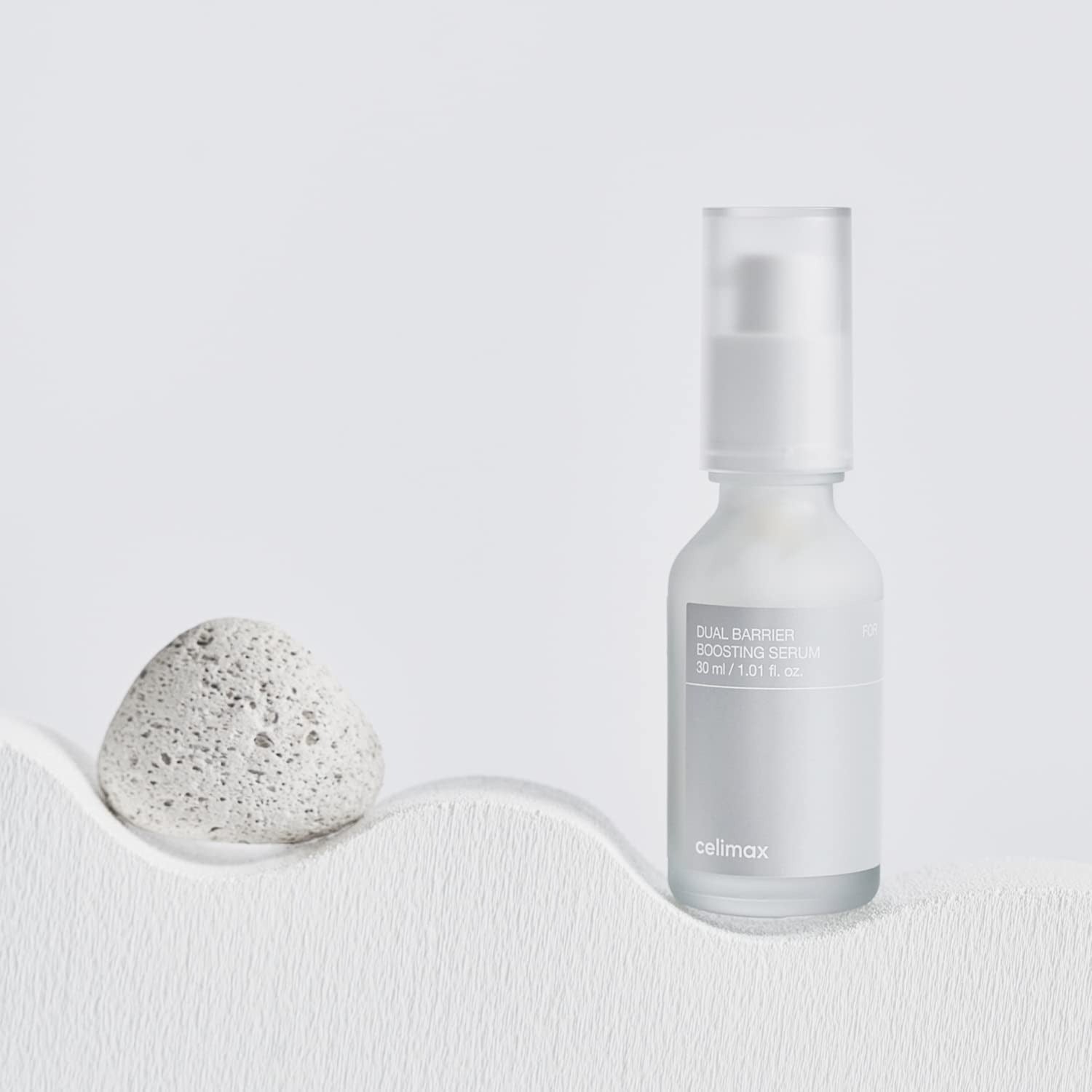 CELIMAX Dual Barrier Boosting Serum 30ml bottle displayed on a minimalist background.