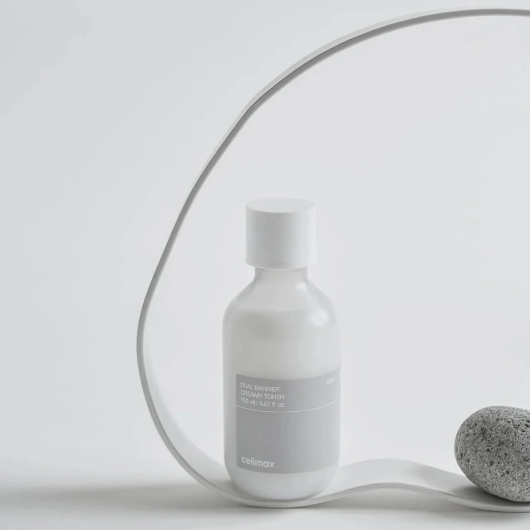 CELIMAX Dual Barrier Creamy Toner 150ml bottle displayed with minimalist decor.