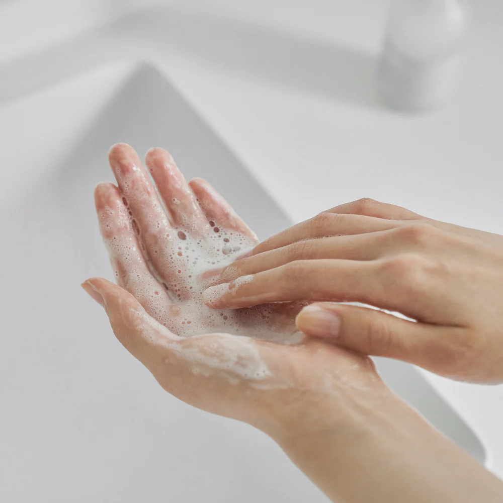 Hands lathering with CELIMAX Dual Barrier Mild Gel Cleanser 200ml for gentle cleansing.