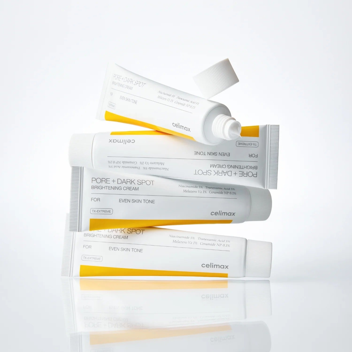 CELIMAX Pore Dark Spot Brightening Cream 35ml tubes stacked on a reflective surface.