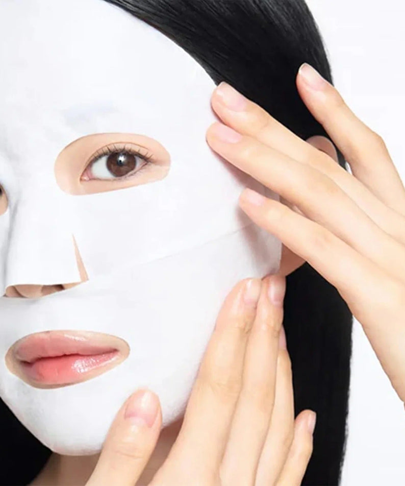 Person applying CELIMAX Brightening Pore Blemish Cream Wrapping Mask 1 Sheets for smooth and radiant skin care routine.