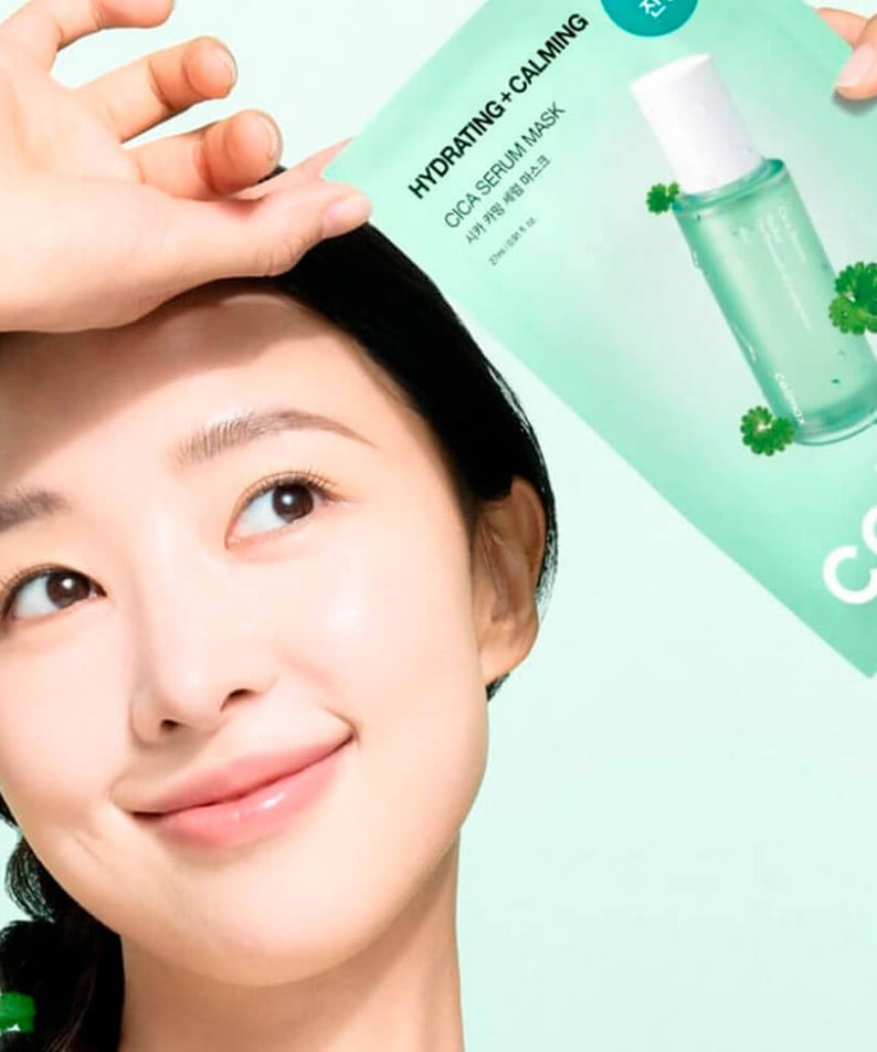 Woman holding CELIMAX Cica Serum Mask 10 Sheets with a smile, promoting hydrating and calming skincare benefits.