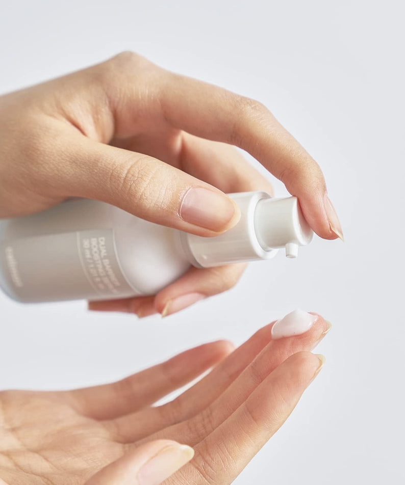 Applying CELIMAX Dual Barrier Boosting Serum 30ml on skin for hydration and protection.
