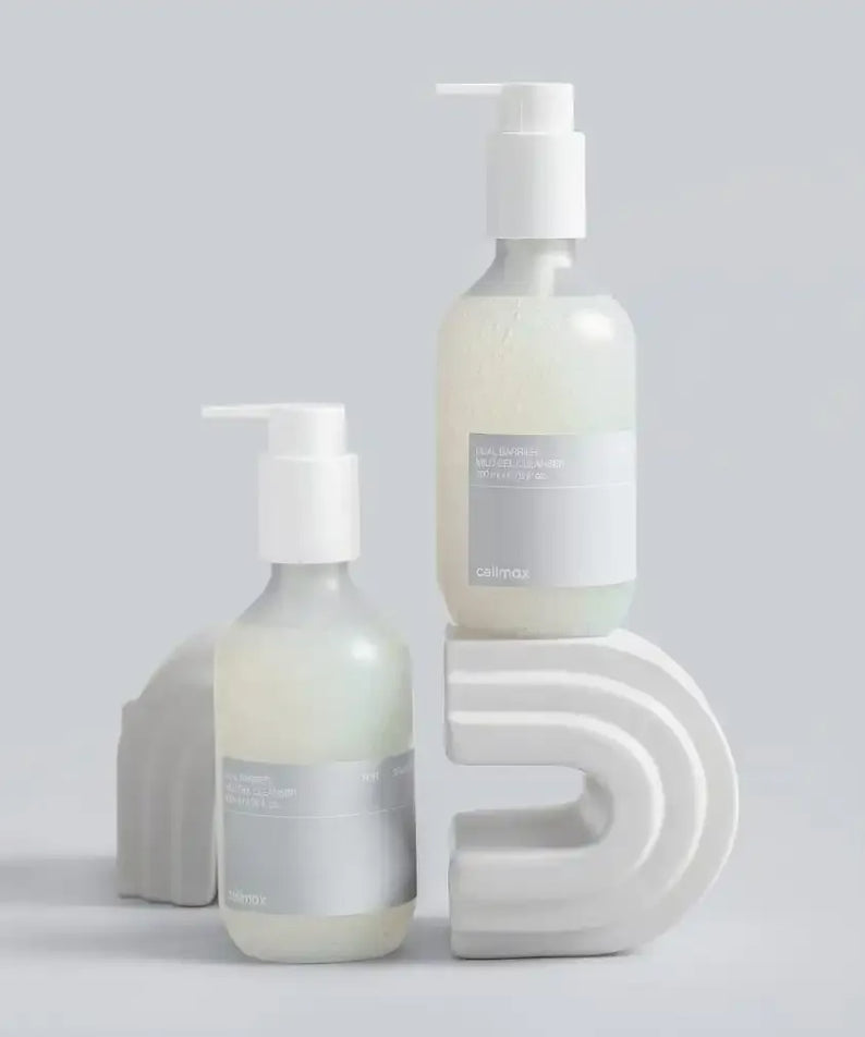CELIMAX Dual Barrier Mild Gel Cleanser 200ml bottles displayed on abstract shapes, showcasing gentle skincare formula