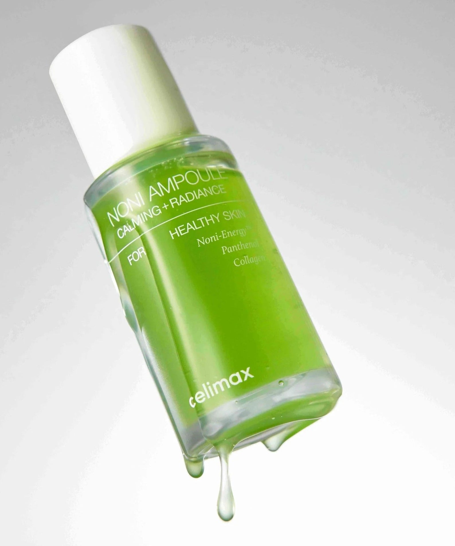 CELIMAX Noni Ampoule Calming+Radiance 100ml bottle with dripping liquid