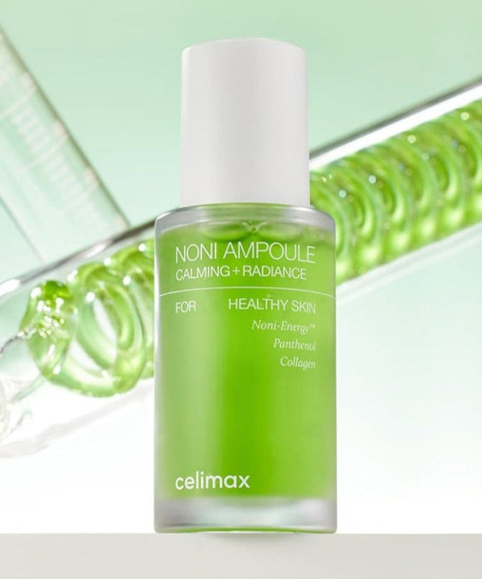 CELIMAX Noni Ampoule Calming+Radiance 30ml in green bottle for healthy skin care on reflective background