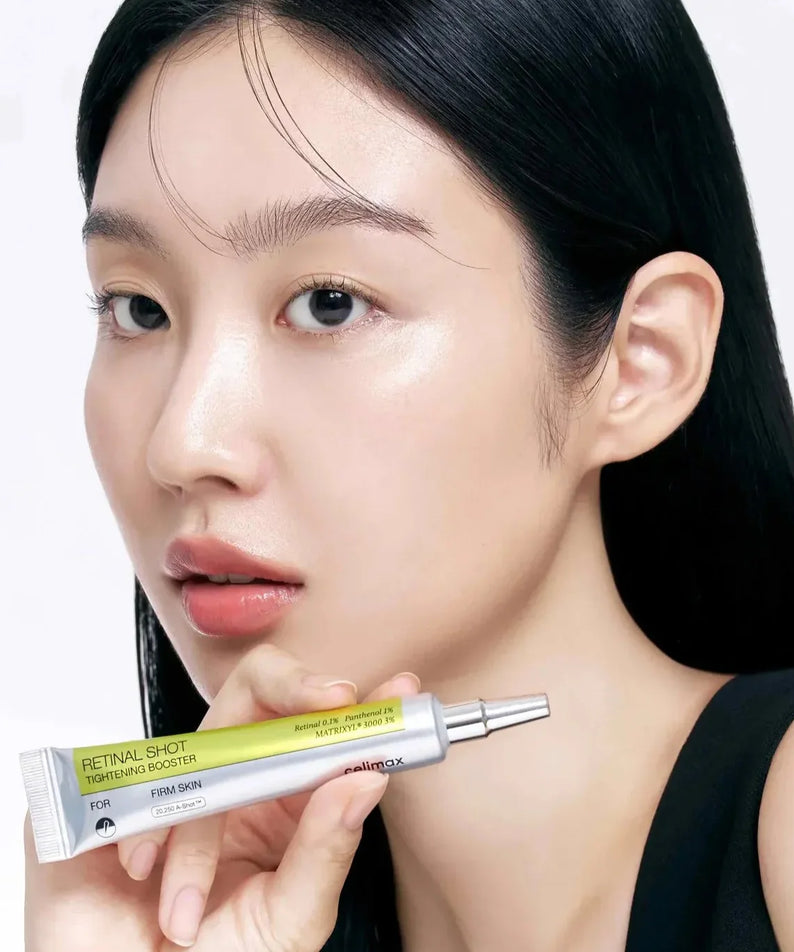 Woman holding CELIMAX Retinol Shot Tightening Booster 15ml, highlighting skincare benefits.