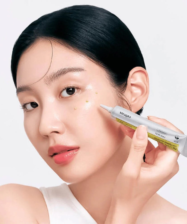 Woman applying CELIMAX Retinol Shot Tightening Booster 15ml to face for skincare