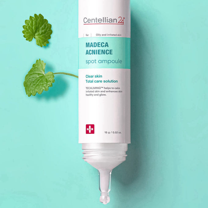 CENTELLIAN 24 Madeca Acne Spot Care 15ml tube on a turquoise background with green leaves.