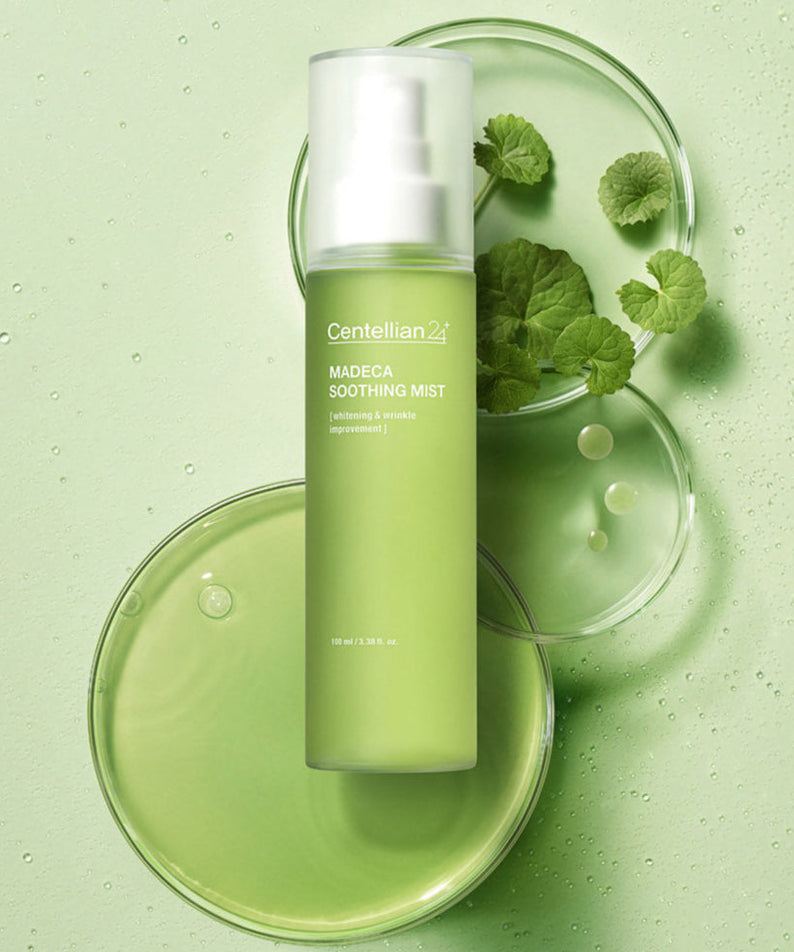 CENTELLIAN 24 Madeca Bottle Grass Mist 100ml on green background with leaves and droplets