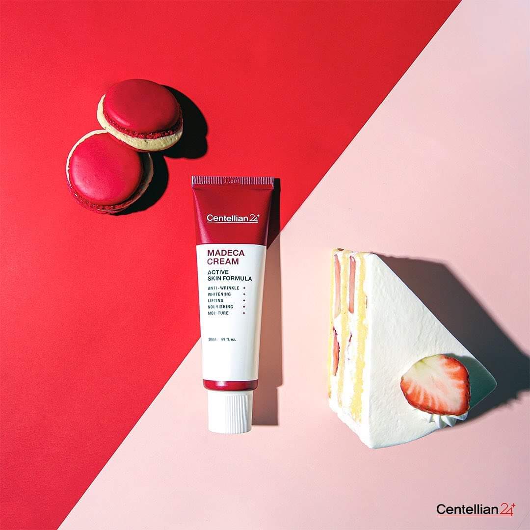 CENTELLIAN 24 Madeca Cream Active Skin Formula 50ml tube on colorful background with dessert.