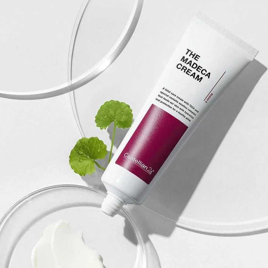 CENTELLIAN 24 The Madeca Cream 50ml tube with glossy background and green leaf, highlighting skincare product features.