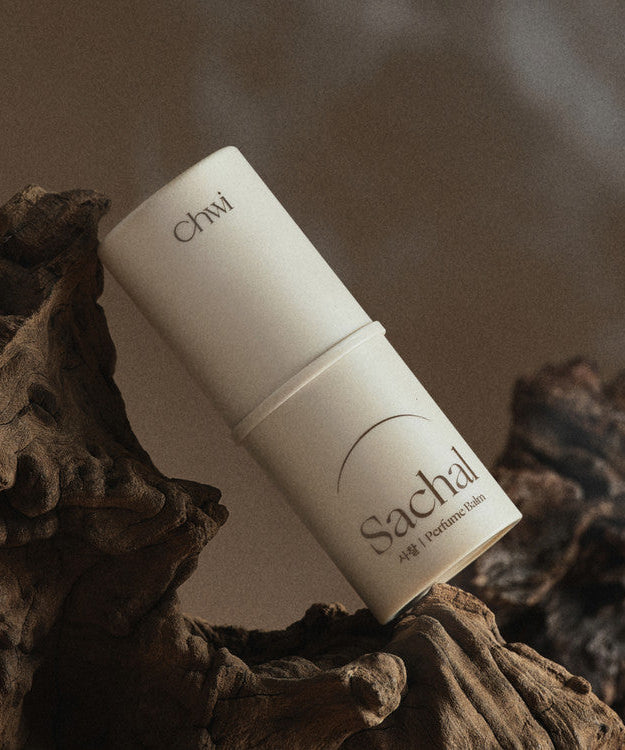 CHWI (CHI) Parfume Balm 4.6g displayed on natural wood setting.