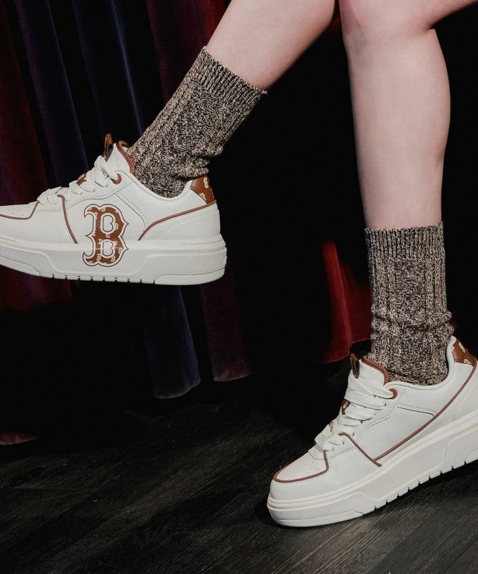 Person wearing MLB CHUNKY LINER BOSTON REDSOX sneakers, showcasing design and style.