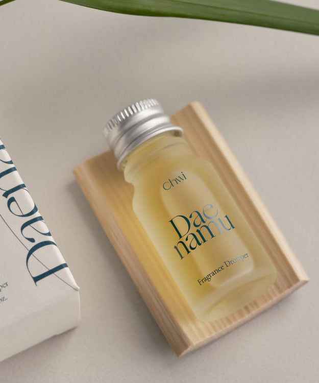 CHWI (CHI) Dae Namu Frangrance Dropper 10ml on wooden tray next to packaging