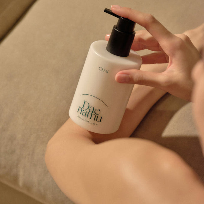 Person applying CHWI (CHI) Dae Namu Hand & Body Lotion 300ml on arm