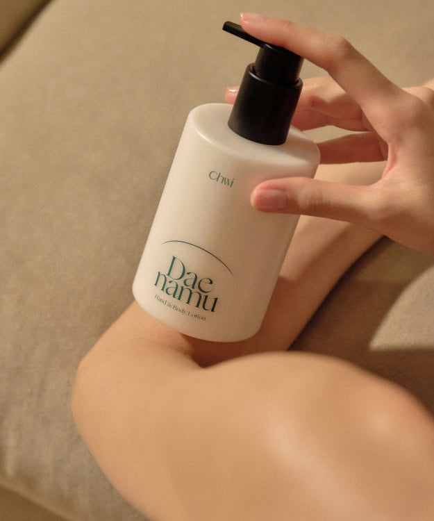 Person applying CHWI (CHI) Dae Namu Hand & Body Lotion 300ml on arm