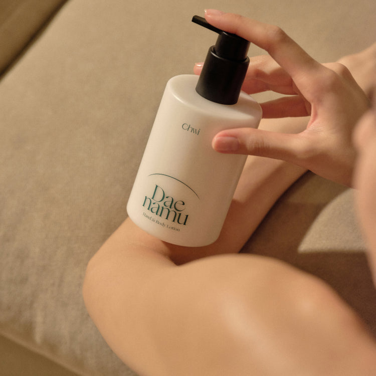 Person applying CHWI (CHI) Dae Namu Hand & Body Lotion 300ml on arm
