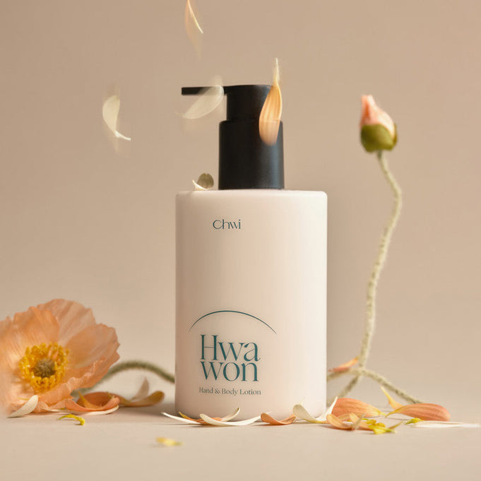 CHWI (CHI) Hwa Won Hand & Body Lotion 300ml surrounded by flowers, featuring a sleek pump bottle design.