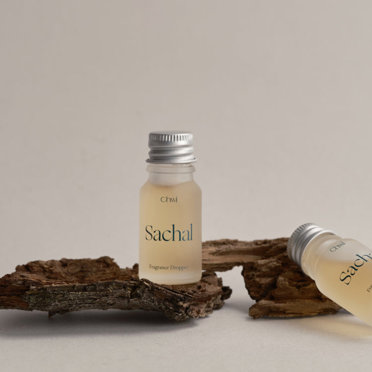 CHWI (CHI) Sachak Fraangrance Dropper 10ml displayed on natural wood, highlighting its elegant packaging and unique scent offering.
