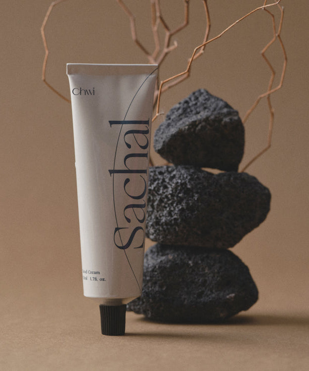 Tube of CHWI (CHI) Sachal Hand Cream 50ml displayed elegantly with natural stones in the background.
