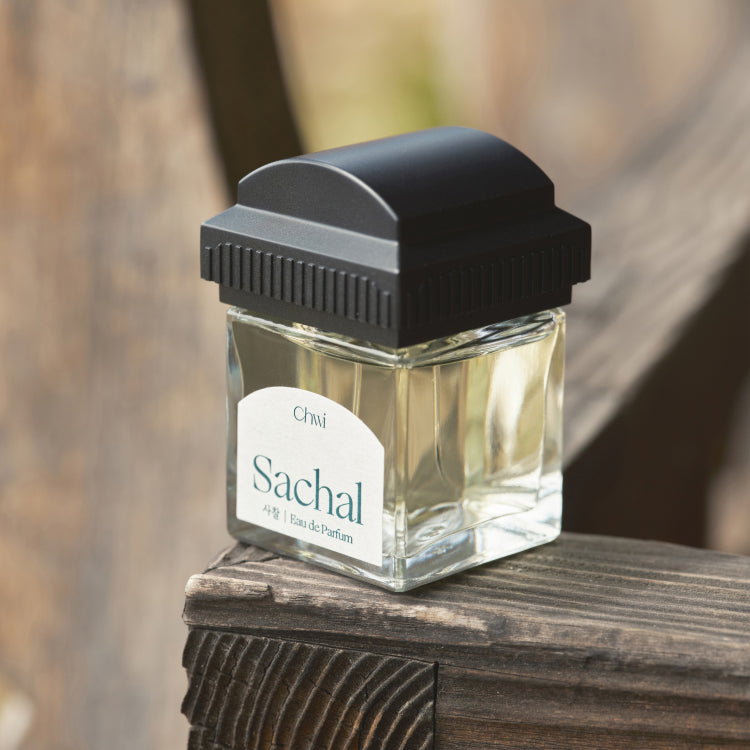 CHWI (CHI) Sachal Parfume 50ml bottle on wooden surface, elegant fragrance container, stylish and sophisticated scent packaging