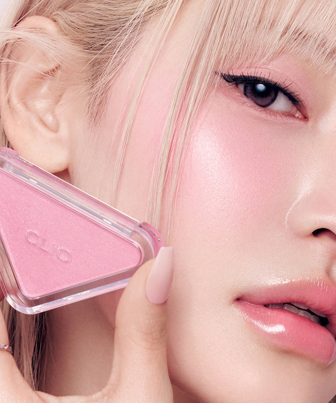 Close-up of a model applying CLIO Essential Blush Tab to cheeks