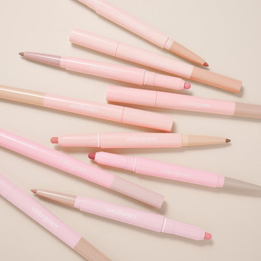Assorted COLORGRAM All In One Over-Lip Maker pencils arranged on a neutral background.