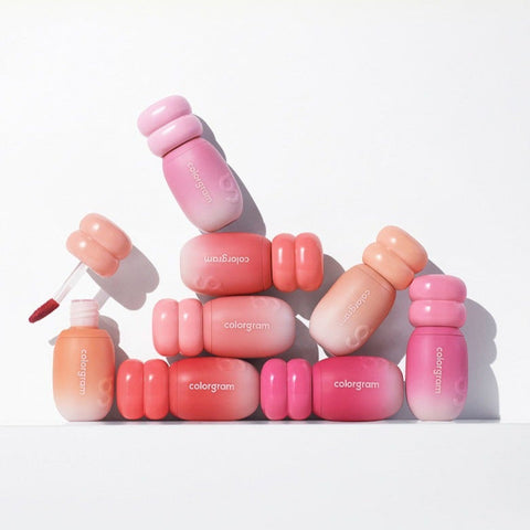 COLORGRAM Juicy Jam Blur Tint 5g collection of vibrant lip tints in pink and peach shades, displayed creatively in a flat lay.