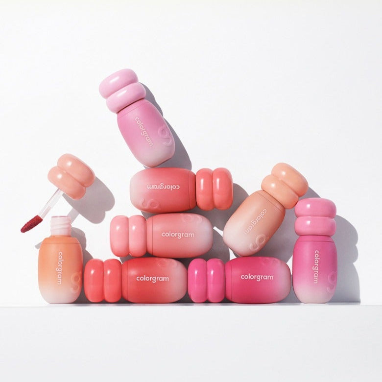 COLORGRAM Juicy Jam Blur Tint 5g collection of vibrant lip tints in pink and peach shades, displayed creatively in a flat lay.