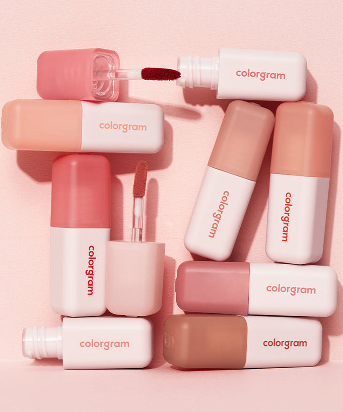 Various COLORGRAM Nude Blur Tint shades on display with stylish packaging.