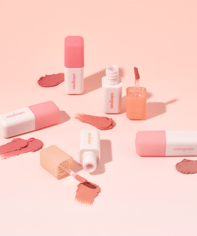 Assorted COLORGRAM Nude Blur Tint products arranged with swatches on a peach background.
