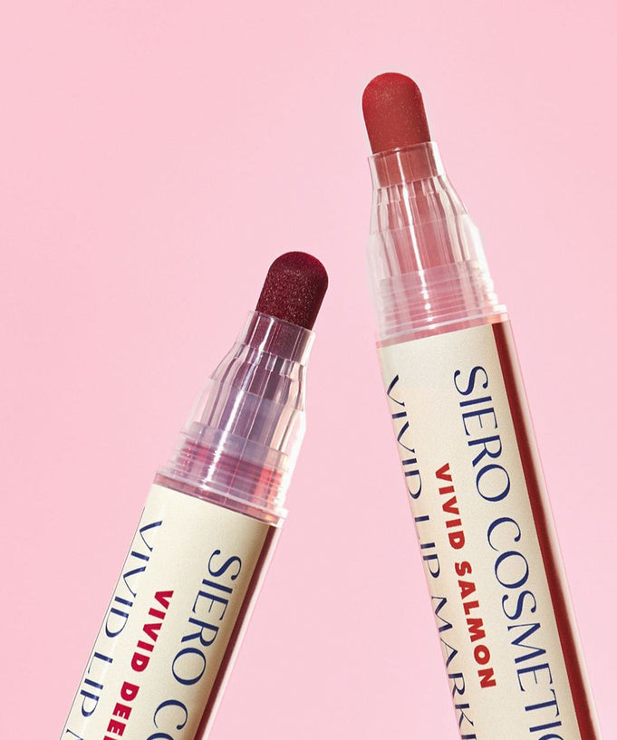 Two shades of COSIERO Vivid Lip Marker against pink background.