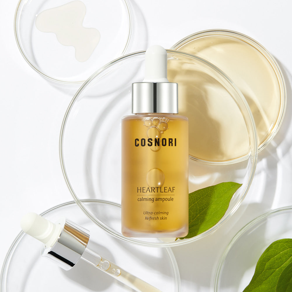Bottle of COSNORI Eoseongcho Calming Ampoule 30ml with pipette, surrounded by skincare elements.