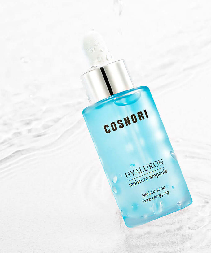 COSNORI Hyaluronic Moisture Ampoule 30ml with hydrating formula and sleek packaging on a water-themed background.