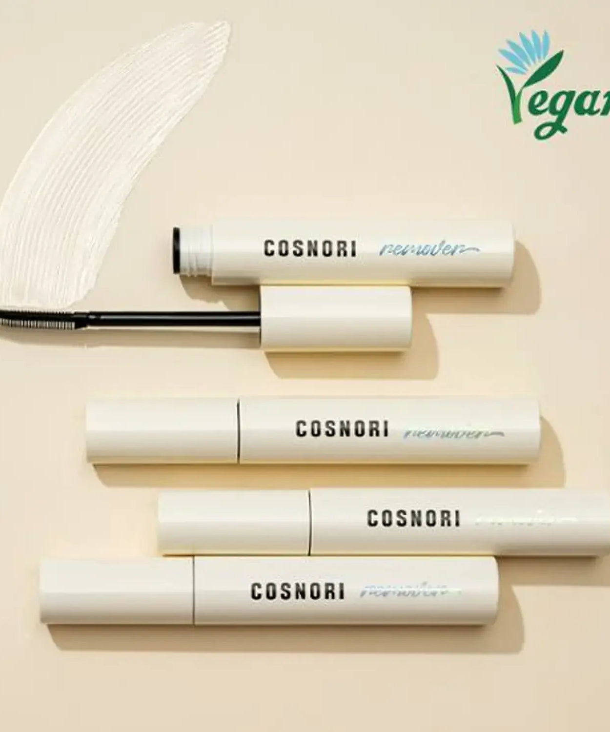 COSNORI Long Active Mascara Remover in white packaging with vegan label, showcasing open and closed tubes on a beige background.