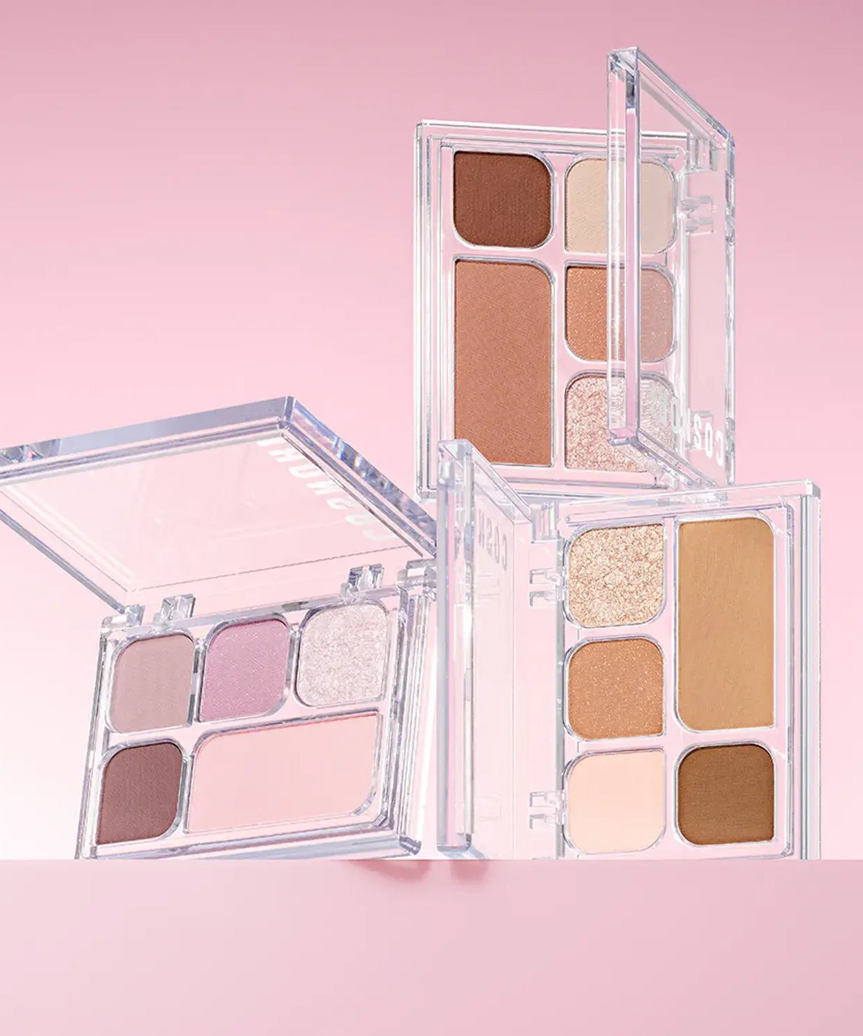 COSNORI My Moment Eye Palette featuring a range of neutral and shimmer eyeshadows in open compact cases on a pink background.