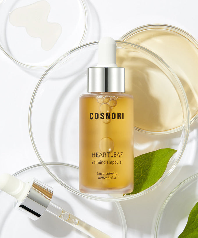 Bottle of COSNORI Eoseongcho Calming Ampoule 30ml with pipette, surrounded by skincare elements.