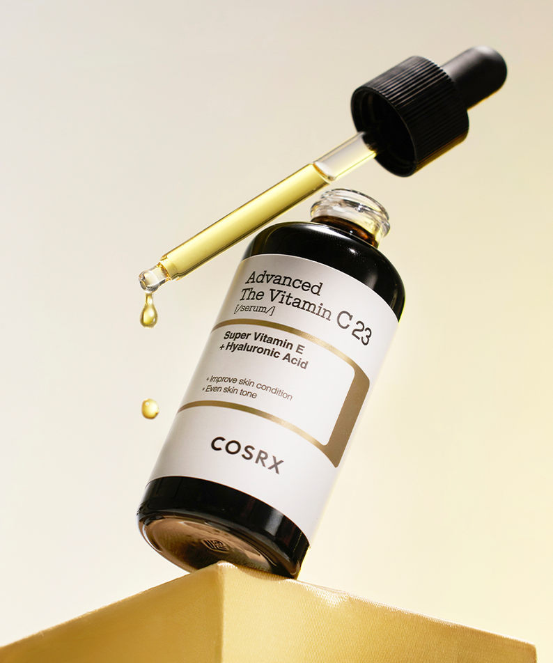 Bottle of COSRX Advanced The Vitamin C 23 Serum with dropper on yellow background