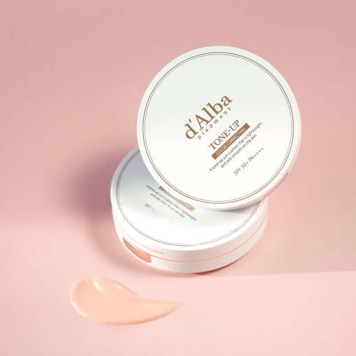 D'ALBA Vegan Tone-Up Sun Cushion 15g on pink surface, open compact showing product texture - SPF, vegan, brightening makeup.
