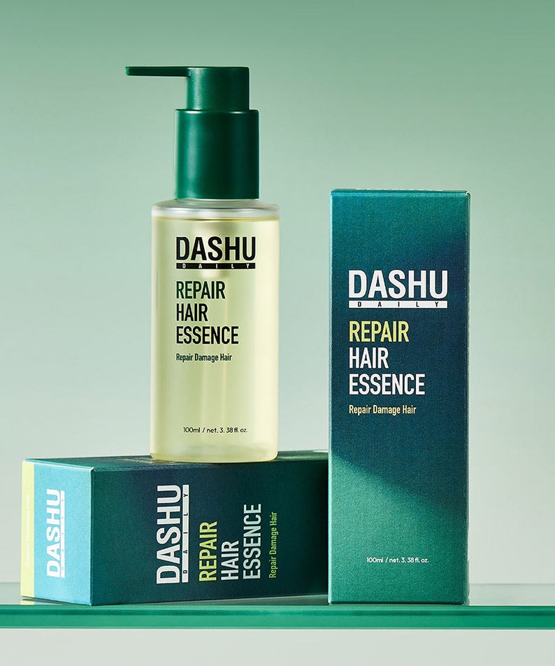 DASHU Daily Repair Hair Essence 100ml bottle with packaging displayed on a green background.