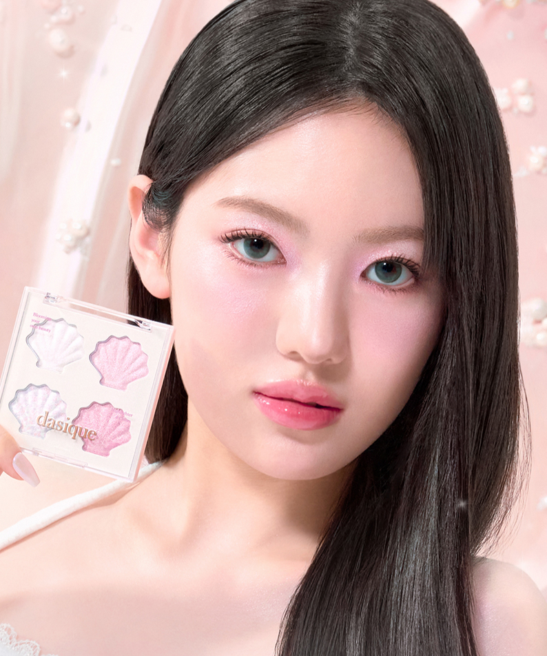 Model holding DASIQUE Shine Glowy Highlighter Palette showcasing makeup application with pastel background.