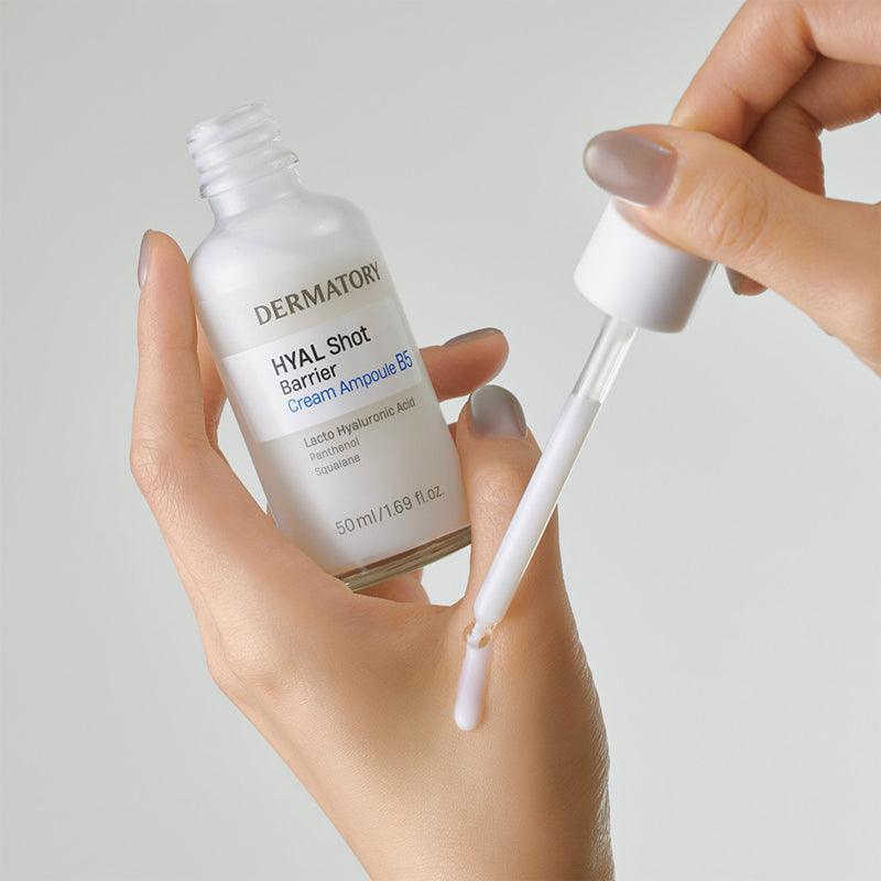 Close-up of a hand holding DERMATORY Hyal Shot Barrier Cream Ampoule B5 50ml with dropper