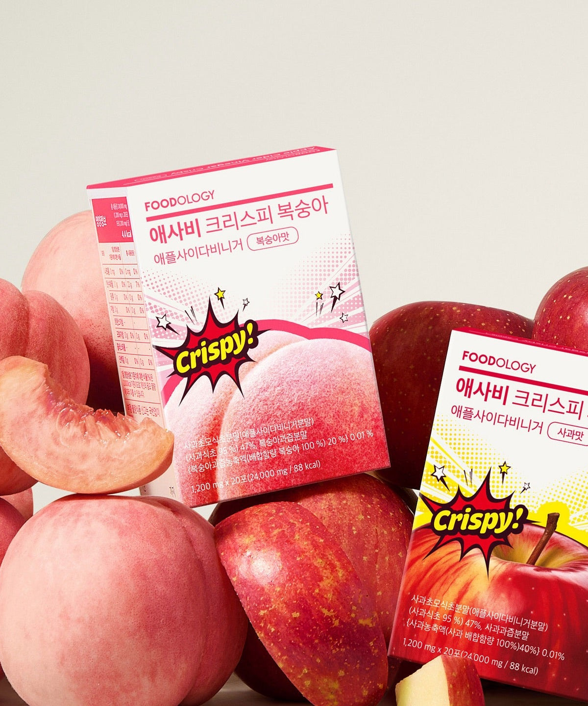 Boxes of FOODOLOGY Asabi Crispy 3 Types with fresh peaches and apples in the background.