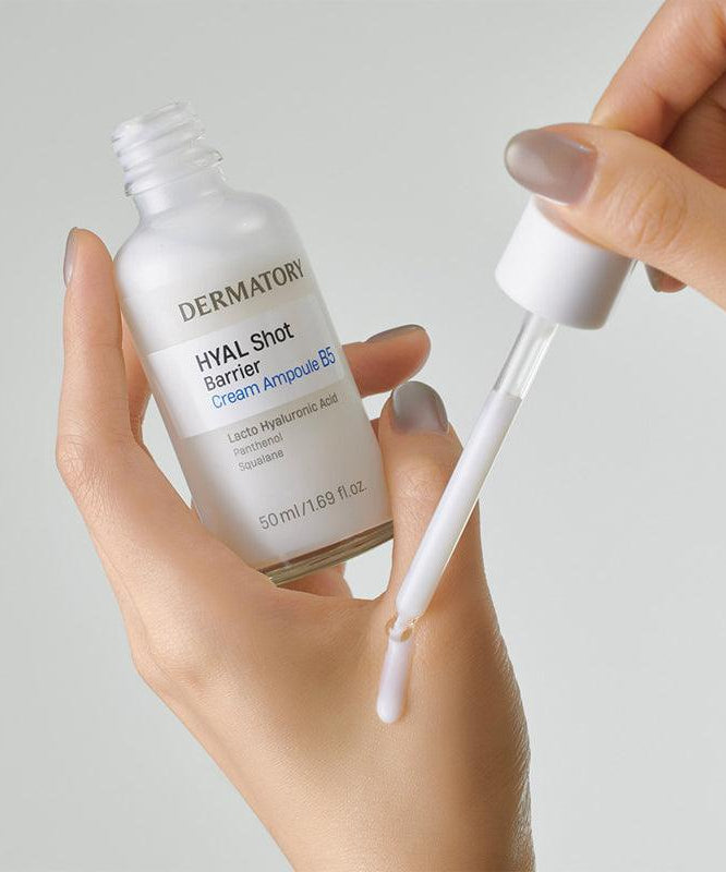 Close-up of a hand holding DERMATORY Hyal Shot Barrier Cream Ampoule B5 50ml with dropper
