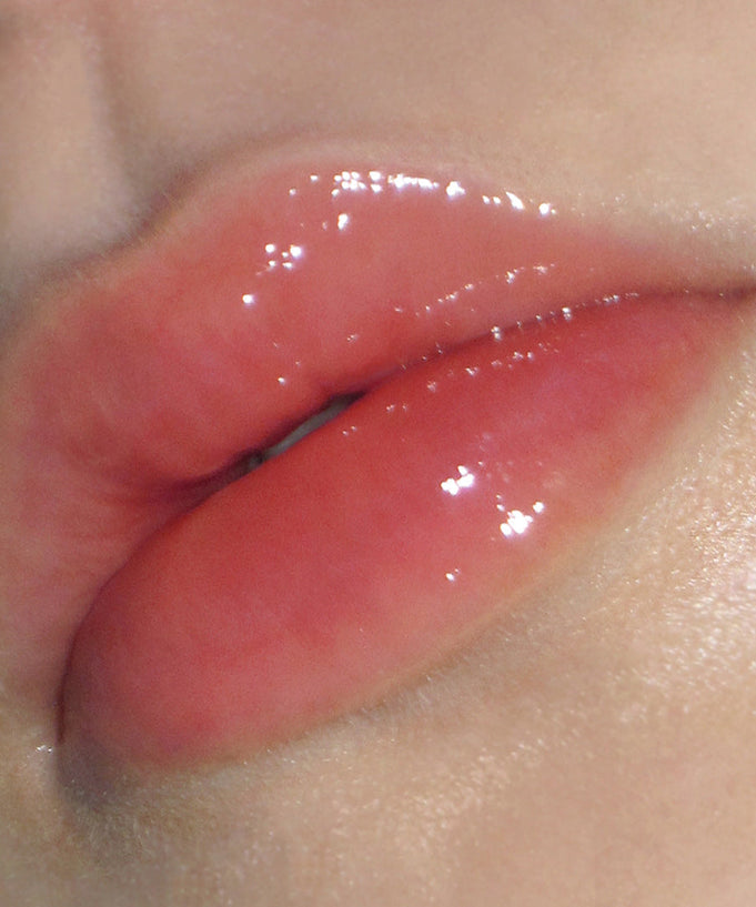 Close-up of glossy lips using DERMATORY Hyaluronic Peptide Lip Keyring, showing hydration and shine.