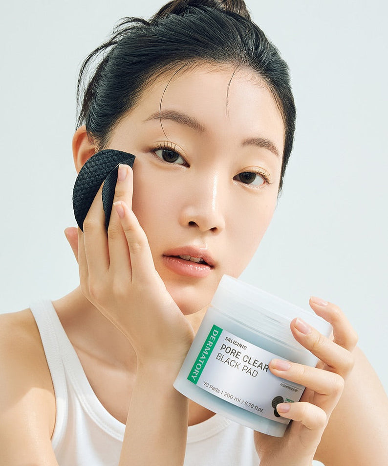 Woman using DERMATORY Salicinic Pore Clear Black Pad 70 Pads for skincare routine