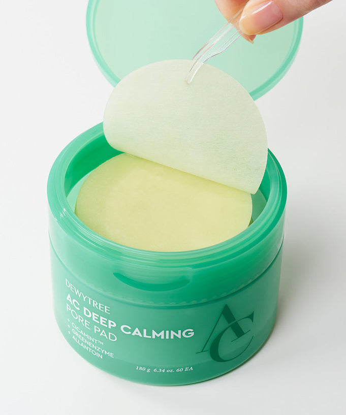 Open jar of DEWYTREE AC Deep Calming Pore Pad 60 Pads with one pad being held up, showing circular design and packaging.